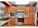 Well-lit kitchen with stainless steel oven and appliances, wood cabinets, and tile backsplash at 618 W Oak Dr, Lakeland, FL 33803