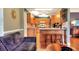 Open kitchen and living space with hardwood floors, breakfast bar, and modern appliances at 618 W Oak Dr, Lakeland, FL 33803
