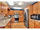 Bright eat-in kitchen with wood cabinets, stainless steel appliances, and lots of counter space at 618 W Oak Dr, Lakeland, FL 33803