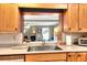 Kitchen sink and breakfast bar with modern appliances and a view into the living space at 618 W Oak Dr, Lakeland, FL 33803