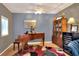 Living room with piano, hardwood floors, area rug, and built in shelving at 618 W Oak Dr, Lakeland, FL 33803