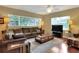 Comfortable living room with large windows, hardwood floors, and ceiling fan at 618 W Oak Dr, Lakeland, FL 33803