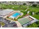 Aerial view of the community pool, shuffleboard courts, and surrounding golf course at 6194 Sanderling Dr, Lakeland, FL 33809