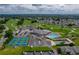 Aerial view of community amenities, including tennis, shuffleboard, and a sparkling pool, all surrounded by golf at 6194 Sanderling Dr, Lakeland, FL 33809