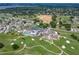 Community aerial view showcasing the pool, tennis courts, golf course, and clubhouse at 6194 Sanderling Dr, Lakeland, FL 33809