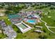 Community aerial view showcasing the pool, tennis courts, golf course, and clubhouse at 6194 Sanderling Dr, Lakeland, FL 33809