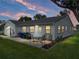 Outdoor patio with seating, a grill, and well-kept landscaping at 6194 Sanderling Dr, Lakeland, FL 33809