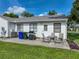 Outdoor patio with table, chairs, grill, and well-kept landscaping at 6194 Sanderling Dr, Lakeland, FL 33809