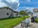 Spacious backyard with a well-maintained lawn and a patio set, ideal for outdoor dining and entertainment at 6194 Sanderling Dr, Lakeland, FL 33809