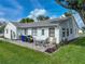Private backyard featuring a well-kept lawn, patio area with seating, and neatly landscaped edges for outdoor enjoyment at 6194 Sanderling Dr, Lakeland, FL 33809