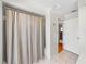 Bathroom area with shower curtain and open doorway to an adjacent room at 6194 Sanderling Dr, Lakeland, FL 33809