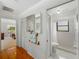 Bathroom area with a tiled shower, closet, and adjacent room view at 6194 Sanderling Dr, Lakeland, FL 33809
