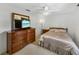 Cozy bedroom featuring ceiling fan, dresser, and bed with light carpet at 6194 Sanderling Dr, Lakeland, FL 33809