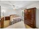 Bedroom with neutral carpet, ceiling fan, side tables, and dark wood furniture at 6194 Sanderling Dr, Lakeland, FL 33809