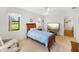 Bright bedroom with ceiling fan, plush recliner, large TV, and a view to the outside at 6194 Sanderling Dr, Lakeland, FL 33809