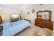 Comfortable bedroom with a large dresser, TV, and a soft recliner at 6194 Sanderling Dr, Lakeland, FL 33809