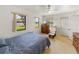 Comfortable bedroom with natural light, dresser, TV, and a relaxing rocking chair at 6194 Sanderling Dr, Lakeland, FL 33809