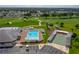 Aerial view featuring a community pool, shuffleboard courts, and lush landscaping in a residential area at 6194 Sanderling Dr, Lakeland, FL 33809