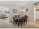 Dining room with chandelier and view of adjacent living room with comfortable seating and view to kitchen at 6194 Sanderling Dr, Lakeland, FL 33809