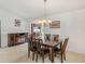 Cozy dining room with a fireplace, television and elegant chandelier above the table at 6194 Sanderling Dr, Lakeland, FL 33809