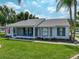 Inviting single-story home with well-maintained lawn and a cozy screened-in porch for relaxed outdoor living at 6194 Sanderling Dr, Lakeland, FL 33809