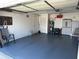 A spacious garage with epoxy floor, overhead storage, and utility features at 6194 Sanderling Dr, Lakeland, FL 33809