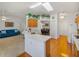 Open kitchen showcasing a skylight, ceiling fan, and connection to the living and dining areas at 6194 Sanderling Dr, Lakeland, FL 33809