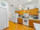 Well-lit kitchen with white appliances, plenty of cabinet space, and laundry room access at 6194 Sanderling Dr, Lakeland, FL 33809