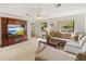 Cozy living room with a large TV, comfortable sectional, and bright natural light at 6194 Sanderling Dr, Lakeland, FL 33809