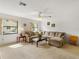 Comfortable living room features neutral decor, large sectional sofa, and sunlit windows at 6194 Sanderling Dr, Lakeland, FL 33809