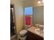 Bathroom with sink, vanity, mirror, toilet, shower, and yellow walls at 629 N Cleveland Ave, Fort Meade, FL 33841