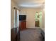 Bedroom with a large window, TV, dresser, and ensuite bathroom at 629 N Cleveland Ave, Fort Meade, FL 33841