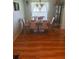 Cozy dining area with a wooden table set and natural light from the window at 629 N Cleveland Ave, Fort Meade, FL 33841