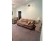 Bright living room featuring a comfortable couch and side chair with a large window at 629 N Cleveland Ave, Fort Meade, FL 33841