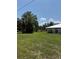 Grassy yard with trees and a house in the background at 629 N Cleveland Ave, Fort Meade, FL 33841