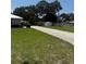 Yard with green grass and a view of the driveway at 629 N Cleveland Ave, Fort Meade, FL 33841