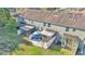 An aerial view of a townhouse backyard with screened enclosures, patio furniture, and a well-maintained lawn at 6435 Sedgeford Dr, Lakeland, FL 33811