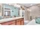 Bright bathroom featuring double sinks, vanity, and a shower with tile surround at 6435 Sedgeford Dr, Lakeland, FL 33811