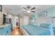 Bright bedroom with a large bed, light blue decor, and ceiling fan at 6435 Sedgeford Dr, Lakeland, FL 33811