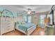 Well-lit bedroom with a large bed, ceiling fan, and light blue decor at 6435 Sedgeford Dr, Lakeland, FL 33811
