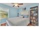 Comfortable bedroom featuring light blue walls, a window, and a bookcase at 6435 Sedgeford Dr, Lakeland, FL 33811