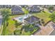 Aerial view of a community pool with lounge chairs, a clubhouse, and surrounding greenery at 6435 Sedgeford Dr, Lakeland, FL 33811