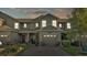 The front exterior of townhouses featuring well-maintained landscaping and private garages at 6435 Sedgeford Dr, Lakeland, FL 33811