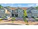 A front exterior of townhouses featuring well-maintained landscaping and private garages at 6435 Sedgeford Dr, Lakeland, FL 33811