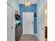 Bright foyer with stylish blue accent wall, tiled flooring, and attractive entryway decor at 6435 Sedgeford Dr, Lakeland, FL 33811