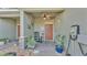 Cozy front porch with rocking chair, plants, and decorative door wreath at 6435 Sedgeford Dr, Lakeland, FL 33811