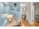 Hallway with wood flooring and decorative shelves and tables at 6435 Sedgeford Dr, Lakeland, FL 33811
