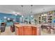 Granite kitchen island with cabinets, pendant lights and view to dining and living spaces at 6435 Sedgeford Dr, Lakeland, FL 33811