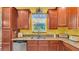 Well-lit kitchen with stainless steel appliances and granite countertops with wood cabinetry at 6435 Sedgeford Dr, Lakeland, FL 33811
