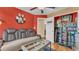 Cozy living room featuring a comfortable couch, a glass-top coffee table, and collectibles on display at 6435 Sedgeford Dr, Lakeland, FL 33811